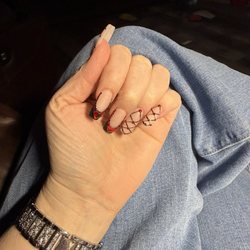 Nail design with red rhinestones and hearts.