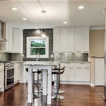 Perezidential Construction - a kitchen with white cabinets and stainless steel appliances - General Contractors Near Me Perezidential Construction - a kitchen with white cabinets and stainless steel appliances - General Contractors Near Me