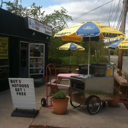 a hot dog cart and umbrellas