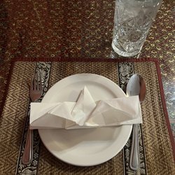 Thai Smile Restaurant - The table setting with a nicely folded napkin.