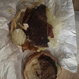 two burgers on a piece of paper