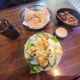 Caesar salad, steak bites and cocktail