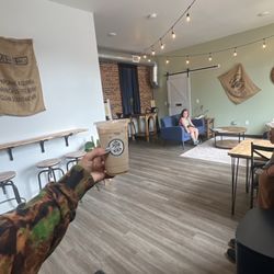 Joe on the Go - Lounge with many seating areas and a restroom.