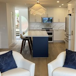 Kari Caldwell Studios - An open-concept living and kitchen space designed for flow, featuring a statement island and layered textures.