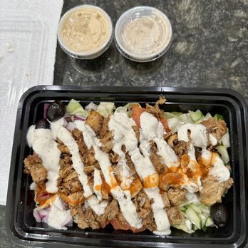 Austin’s Habibi  - Habibi Salad with dressing and side of hummus - Mediterranean Near Me - Austin, Texas