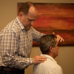 Vellore Chiropractic & Wellness Centre - Vaughan Chiropractor Dr. Matthew Bortolussi examining a patient.