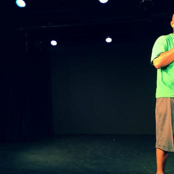 The Playroom Theater - a man singing into a microphone - Music Venues Near Me - New York, New York The Playroom Theater - a man singing into a microphone - Music Venues Near Me - New York, New York