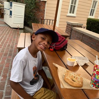 Regal Eagle Smokehouse: Craft Drafts & Barbecue - Epcot regal eagle smokehouse, Sampson enjoying his Mickey ears pretzel. - Barbeque Near Me - Lake Buena Vista, Florida Regal Eagle Smokehouse: Craft Drafts & Barbecue - Epcot regal eagle smokehouse, Sampson enjoying his Mickey ears pretzel. - Barbeque Near Me - Lake Buena Vista, Florida