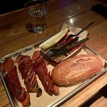 The Sampler with Smoked Hungarian, Cheddar Jalapeño, Spicy Polish, a grinder roll, mushroom, onions, and bell peppers