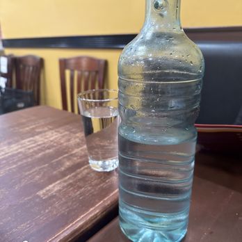 Niramish Indian Cuisine - a bottle of water on a table - Indian Near Me - Atlanta, Georgia Niramish Indian Cuisine - a bottle of water on a table - Indian Near Me - Atlanta, Georgia