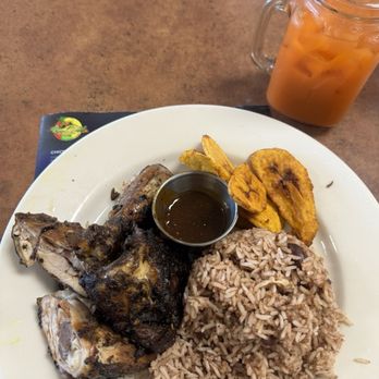 Rockyaad Jamaican Restaurant - Jerk chicken with rice and peas, and fried plantains. Ginger carrot juice to wash it down. - Caribbean Near Me - Carmichael, California