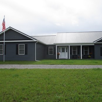Alvord Builders - a gray house with a flag on the roof - General Contractors Near Me - Batavia, New York Alvord Builders - a gray house with a flag on the roof - General Contractors Near Me - Batavia, New York