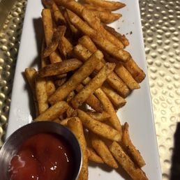 French fries with Cajun seasoning and a side of ketchup