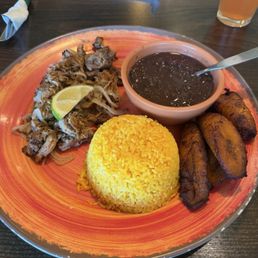 Lechon Asado, Yellow Rice, Black Bean Soup, & Sweet Plantains.
