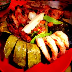El Molcajete Mexican Restaurant & Sea Food - Molcajete filled w/ camerones, chuleta, chorizo, nopales, avocado, cambray, queso, & fried jalapeno
