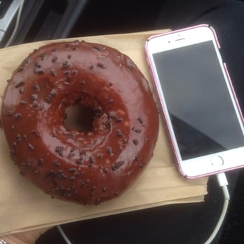 Doughnut Vault - Chocolate glazed doughnut (phone for scale) - Donuts Near Me - Chicago, Illinois Doughnut Vault - Chocolate glazed doughnut (phone for scale) - Donuts Near Me - Chicago, Illinois