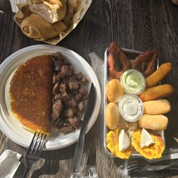 Tia Juana appetizer plate, cachito (sandwich), cachapa with picaña Tia Juana appetizer plate, cachito (sandwich), cachapa with picaña