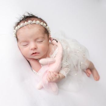 Hudzen Photography - newborn baby girl with a swan toy - Session Photography Near Me Hudzen Photography - newborn baby girl with a swan toy - Session Photography Near Me