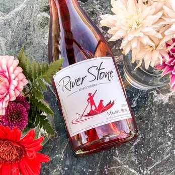 River Stone Estate Winery - a bottle of wine and flowers - Wineries Near Me - Oliver, British Columbia River Stone Estate Winery - a bottle of wine and flowers - Wineries Near Me - Oliver, British Columbia