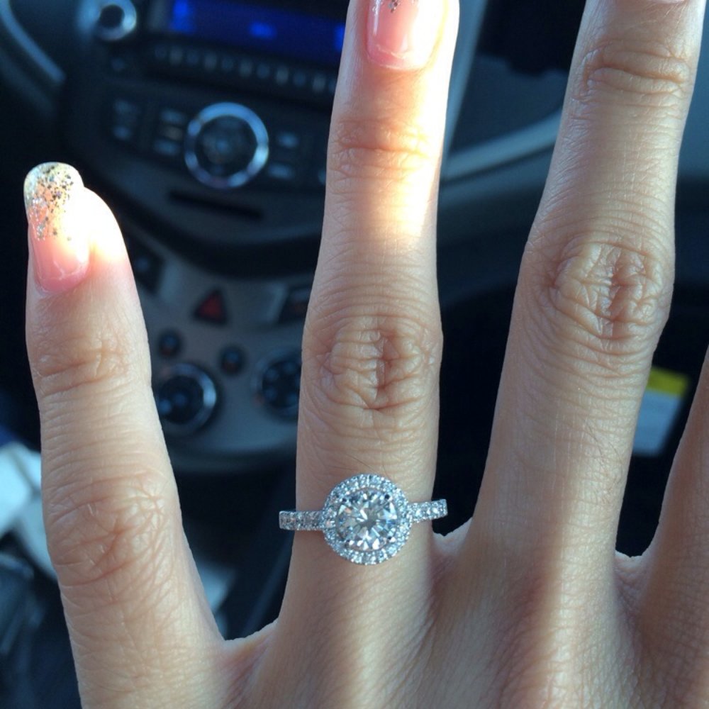 My fiancé's ring. A 3/4 karat solitaire with a diamond halo just a tad below it. White gold band with diamonds. My fiancé's ring. A 3/4 karat solitaire with a diamond halo just a tad below it. White gold band with diamonds.