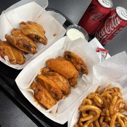 Sweet chili and buffalo hot wings and curly fries. Sweet chili and buffalo hot wings and curly fries.