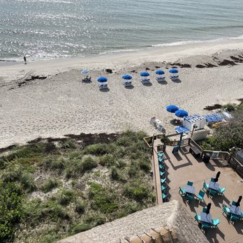 Crowne Plaza Melbourne - Oceanfront by IHG - View of the restaurant patio and stage, with beach chairs set up - Hotels Near Me - Melbourne, Florida