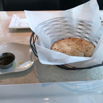 Tanoor - A welcoming complementary warm pita bread(s) with parsley infused olive oil. - Lebanese Near Me - Sammamish, Washington Tanoor - A welcoming complementary warm pita bread(s) with parsley infused olive oil. - Lebanese Near Me - Sammamish, Washington
