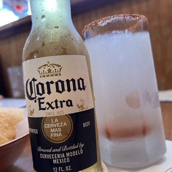 Los Perez Mexican Restaurant - a bottle of corona extra next to a glass of beer - Mexican Near Me - Houston, Texas Los Perez Mexican Restaurant - a bottle of corona extra next to a glass of beer - Mexican Near Me - Houston, Texas