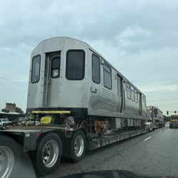 Dempster-Skokie - A very unusual sighting: 2 brand new CTA rail cars being transported on flat bed carriers on Dempster St.