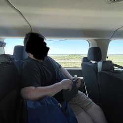 Small van and speaker wire across window.
