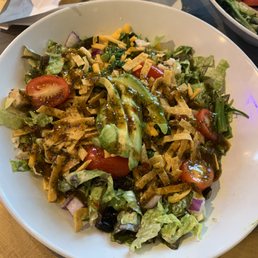 a plate of salad and a bowl of salad