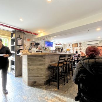 The Inkan - a woman standing at a counter in a restaurant - Peruvian Near Me - Long Island City, New York
