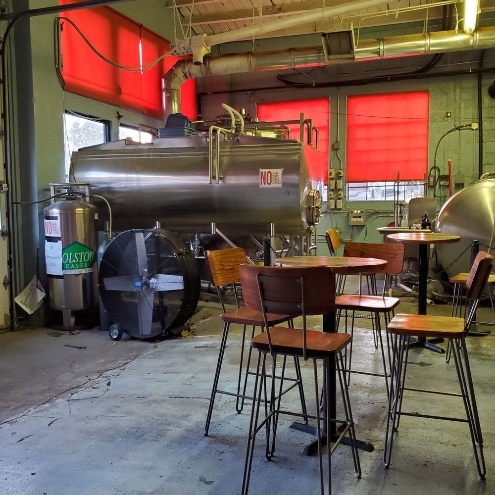 Hi-Wire Brewing - tables and chairs in a brewery - Breweries Near Me - Asheville, North Carolina Hi-Wire Brewing - tables and chairs in a brewery - Breweries Near Me - Asheville, North Carolina