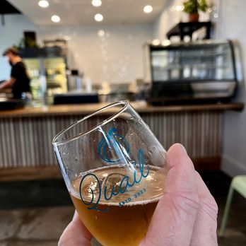 Quail - a person holding a glass of beer - Beer Bar Near Me - Temecula, California