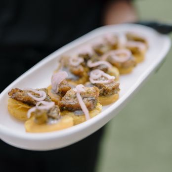 Blend Catering - Plantain tostone. Black bean purée, Cuban style pork belly, Mojo, pickled shallot. - Caterers Near Me Blend Catering - Plantain tostone. Black bean purée, Cuban style pork belly, Mojo, pickled shallot. - Caterers Near Me