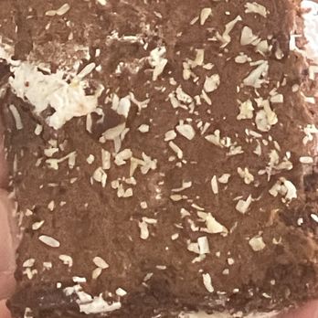 Enzo's Cafe And Bakery - The white on the bottom is coconut. - Bakeries Near Me - Palm Springs, Florida Enzo's Cafe And Bakery - The white on the bottom is coconut. - Bakeries Near Me - Palm Springs, Florida