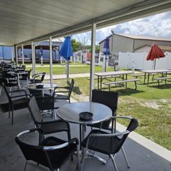 MT Skullz Tavern - Outback patio and table area for smoking,  cornhole and bands