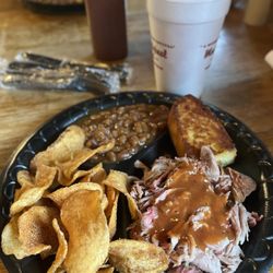 Moe's Original BBQ - Pulled pork plate with baked beans, house made chips and cornbread