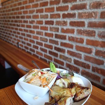 Pestle Rock - Isaarn bbq lunch set of chicken with a side of sticky rice and papaya salad. Get chicken over pork as the chicken has more flavor of curry! - Thai Near Me - Seattle, Washington