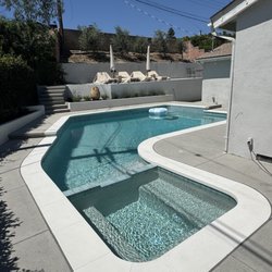 Deluxe Pool - Custom white coping and white mini pebble finish