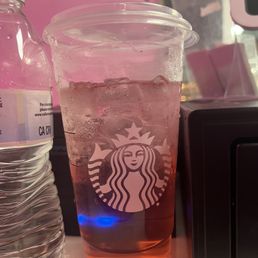 a cup of iced tea and a bottle of water a cup of iced tea and a bottle of water