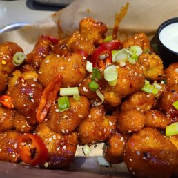 a bowl of buffalo wings with a side of ranch dressing a bowl of buffalo wings with a side of ranch dressing