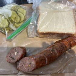 True Texas BBQ - Poblano queso sausage link with bread, pickles and onions