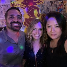 three people posing for a picture three people posing for a picture