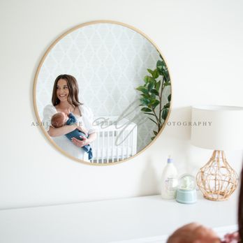 Ashley Line Photography - lifestyle newborn session mom smiling in reflection of the mirror holding baby boy - Session Photography Near Me Ashley Line Photography - lifestyle newborn session mom smiling in reflection of the mirror holding baby boy - Session Photography Near Me