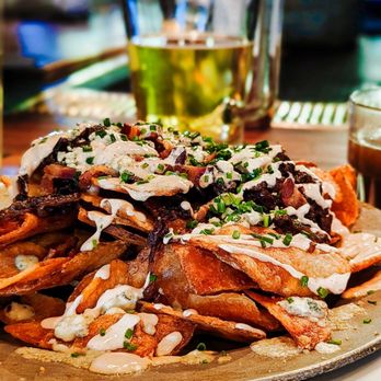 Windsor - The Loaded Chips! Drizzled with caramelized onions, bacon, Bleu cheese, and a chipotle crema... - New American Near Me - Phoenix, Arizona Windsor - The Loaded Chips! Drizzled with caramelized onions, bacon, Bleu cheese, and a chipotle crema... - New American Near Me - Phoenix, Arizona