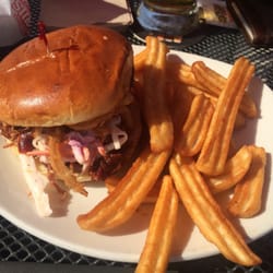 St. Louis Bar & Grill - Pulled pork lunch special with cole slaw, onion straws, Memphis sauce on a brioche with fries.