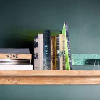 Niu Wine - a shelf of books on a green wall - Wine Bars Near Me - Miami, Florida Niu Wine - a shelf of books on a green wall - Wine Bars Near Me - Miami, Florida