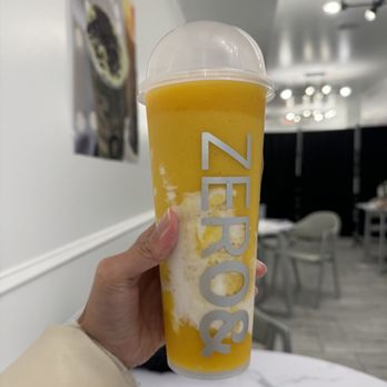 ZERO& - Newbury - a person holding a cup of orange juice - Bubble Tea Near Me - Boston, Massachusetts ZERO& - Newbury - a person holding a cup of orange juice - Bubble Tea Near Me - Boston, Massachusetts