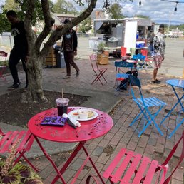 Seating area, plate of pupusas, food truck Seating area, plate of pupusas, food truck